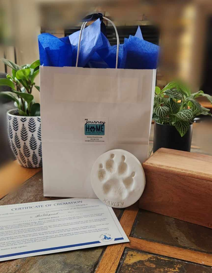 a white bag with blue wrapping paper and a paw print on it